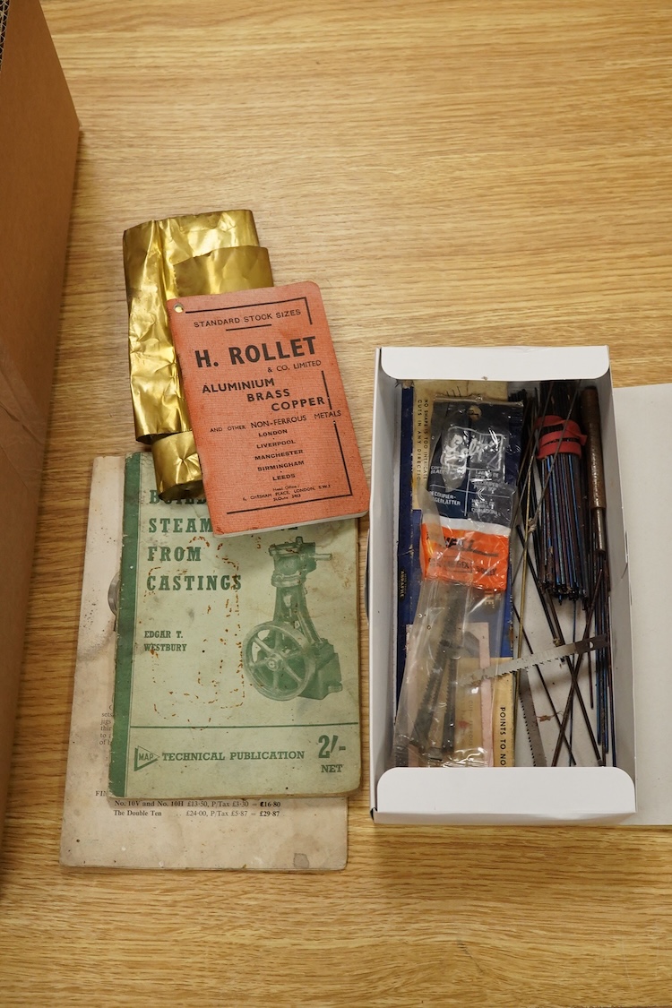 A Stuart No.10 vertical live steam single cylinder stationary engine, together with the original instruction booklets, a book on Sterling engines, and a quantity of useful ferrous and non-ferrous rods